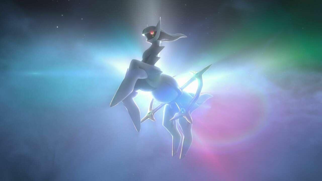 Arceus in front of a bright light and rainbow colored space rift