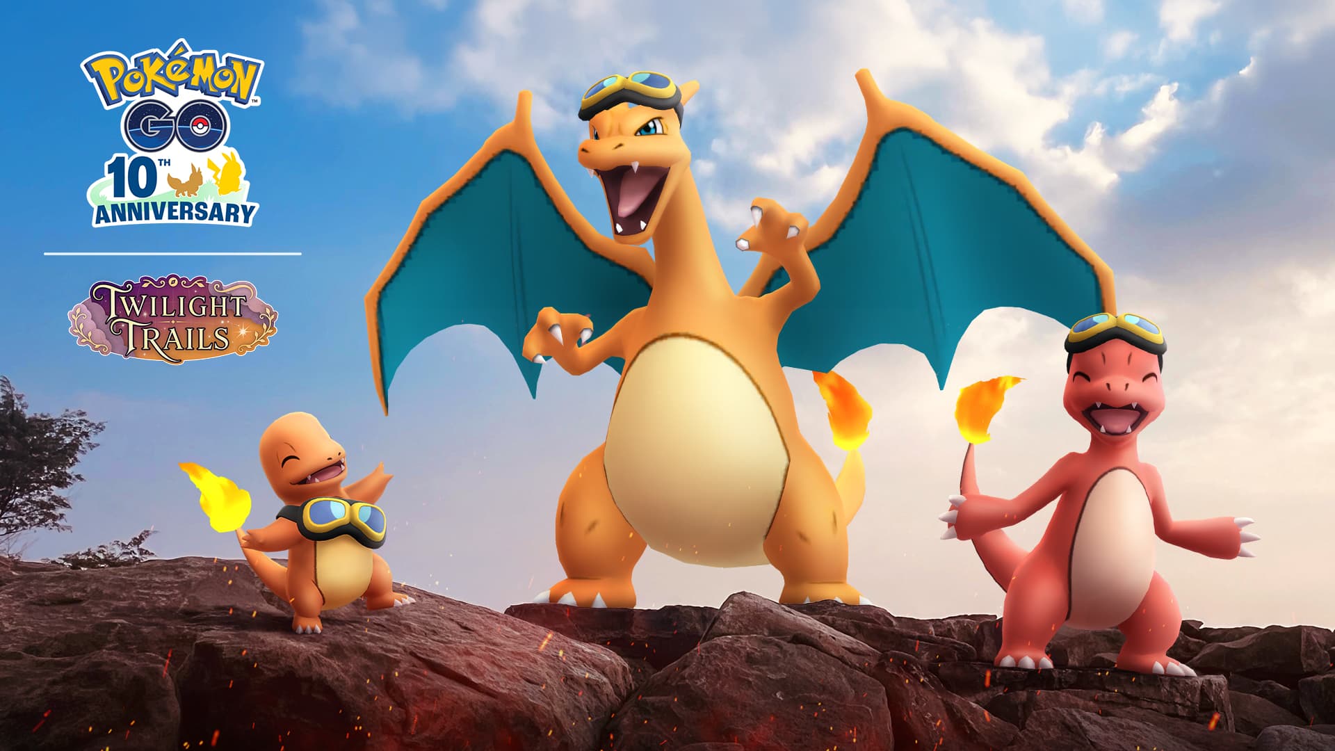 Pokemon Horizons the Series Celebration Event with Charmander, Charizard, and Charmeleon on top of some rocks. All are wearing goggles.