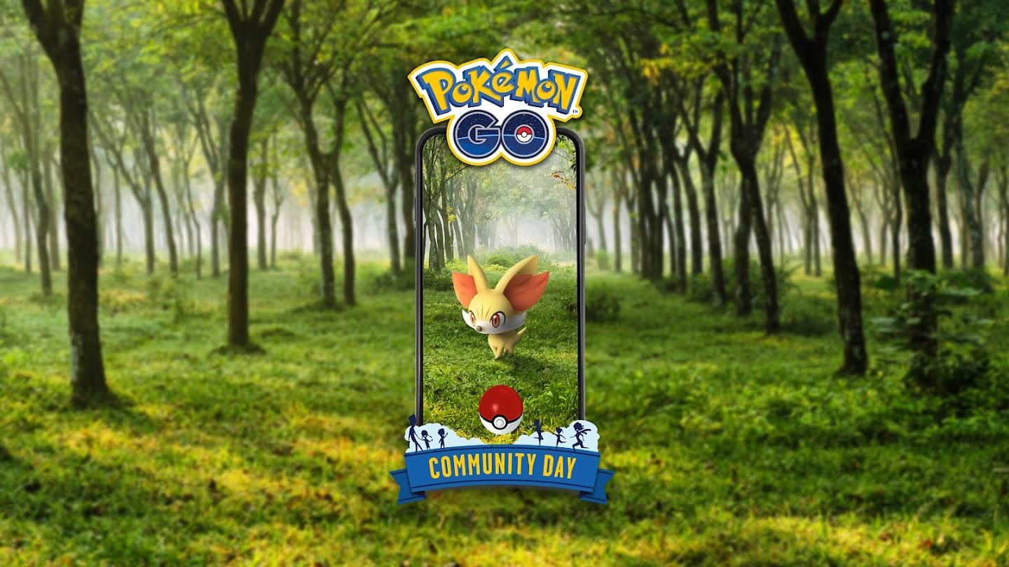 A phone with Fennekin inside with a Pokéball. The logo for Pokémon Go appears along with the "Community Day Logo". Everything is in front of a forest landscape